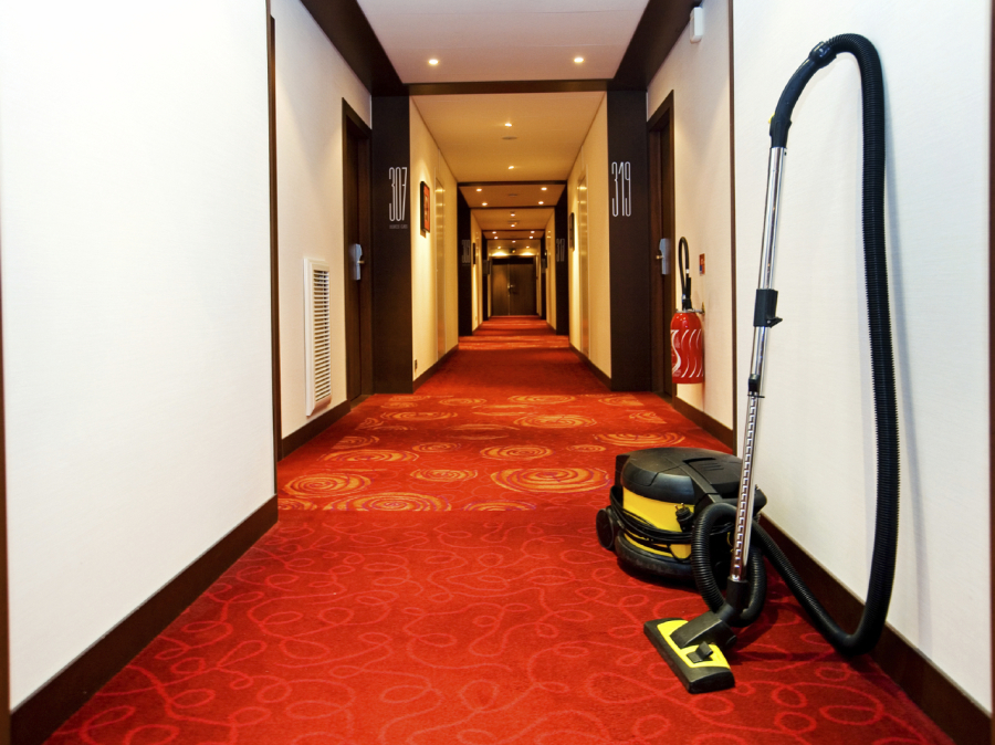 Hotel hallway being vacuumed