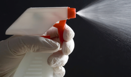 Spraying cleaner on office equipment